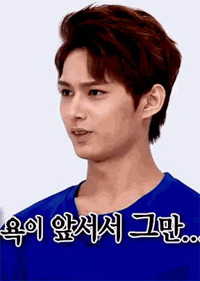 a young man in a blue shirt with chinese writing on it