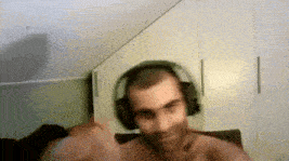 a man without a shirt is wearing headphones
