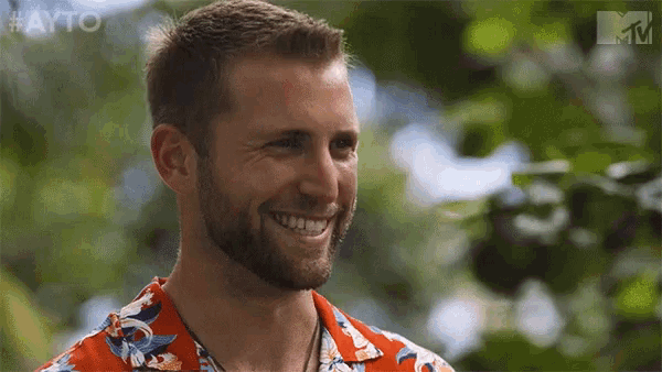 a man in a hawaiian shirt is smiling with the hashtag #ayo on the bottom right