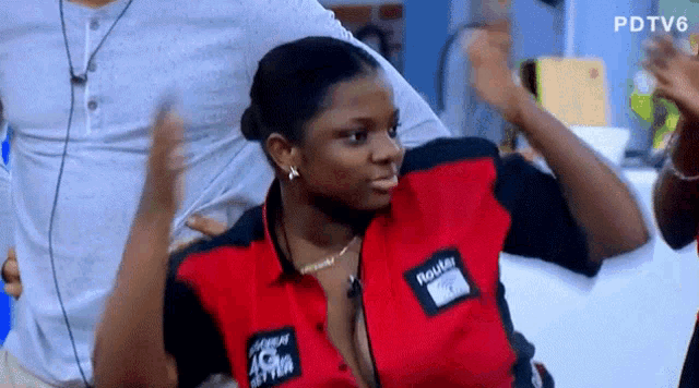 a woman in a red and black shirt that says raider on it