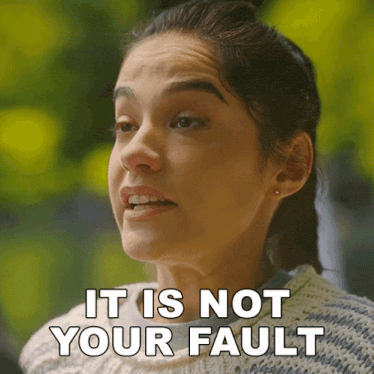 a woman says it is not your fault in a sweater