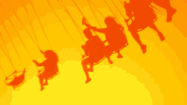 the shadows of people riding swings are against a bright yellow background
