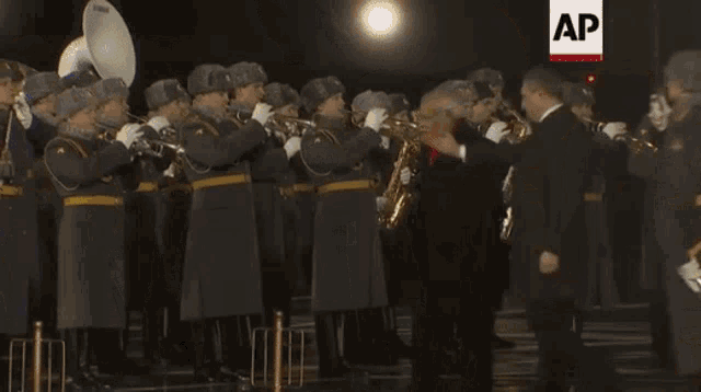 a group of men in military uniforms are playing instruments in front of an ap headline