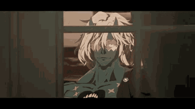a man with horns is looking out of a window .