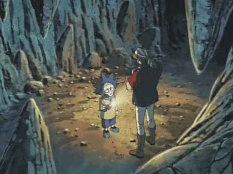a man and a little boy are standing in a cave