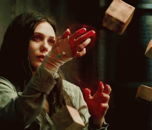 a woman with blood on her hands is holding a wooden block .