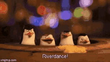 a group of penguins are standing next to each other in a hole in the ground .