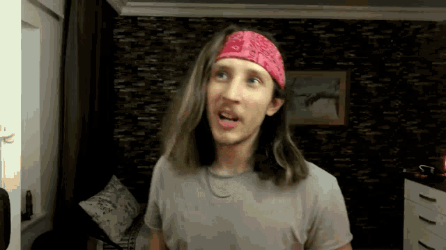 a man with long hair and a bandana on his head
