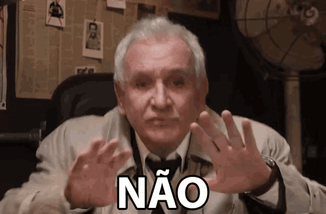 a man in a trench coat has the word não on his face