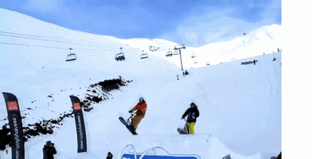 a snowboarder with the number 10 on his board is going down a snowy slope
