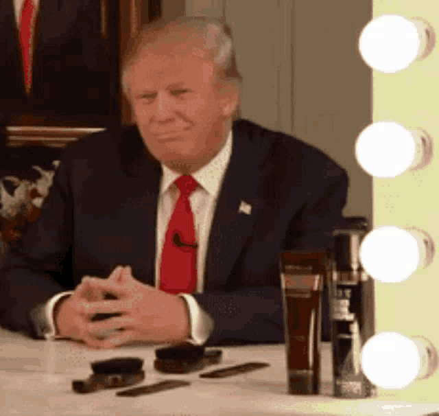 donald trump is sitting in front of a vanity mirror