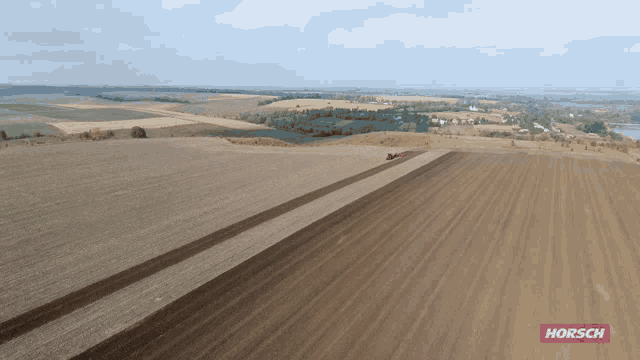 an aerial view of a dirt field with a horsch logo on the bottom