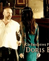 a man and a woman are standing next to each other with the name doris on the bottom right