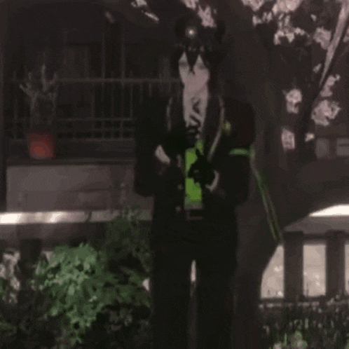 a man with horns is holding three red hearts in his hands .