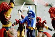 a group of cartoon characters are fighting each other with swords and gloves .
