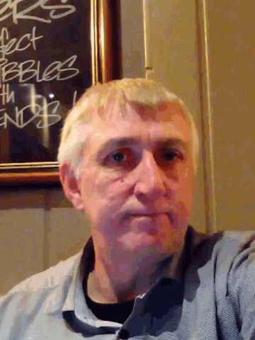 a man stands in front of a chalkboard that says " perfect bebles "