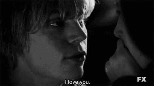 a man and a woman are kissing in a black and white photo and the woman is saying `` i love you '' .