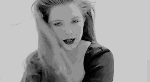 a black and white photo of a woman with long red hair .