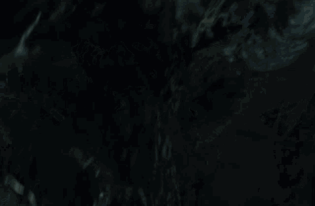 a close up of a monster 's face with teeth and a beard