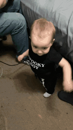 a baby wearing a shirt that says spooky boy