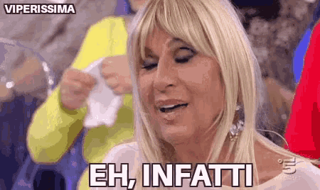 a woman with blonde hair is crying and saying eh , infatti .