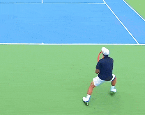 a man laying on a tennis court with his arms up