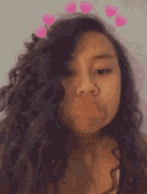 a girl wearing a headband with hearts on it