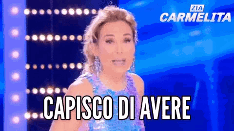 a woman in a sequined dress is standing in front of a sign that says zia carmelita