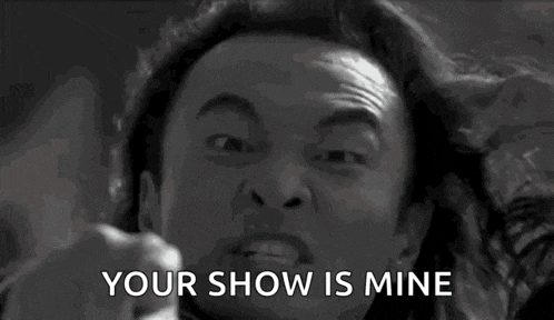 a black and white photo of a man screaming and pointing at the camera with the words `` your show is mine '' .