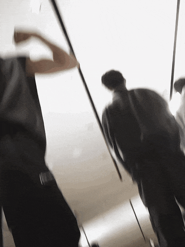a blurry picture of a man holding a pole