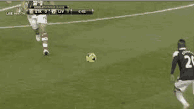 a soccer player is kicking a soccer ball on the field .