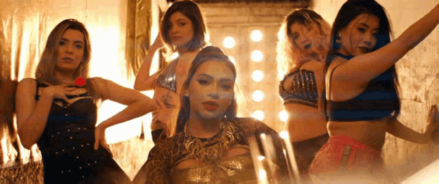 a group of women are posing for a picture and one of them is wearing a leopard print top