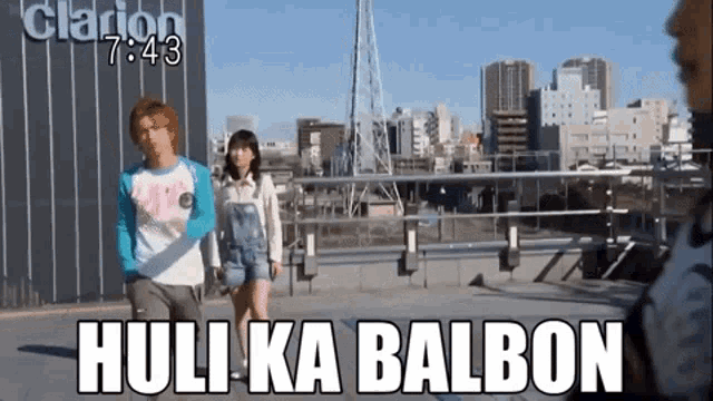 a man and a woman are standing on a balcony with the words huli ka balbon