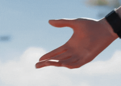 a close up of a person 's hand reaching out towards something