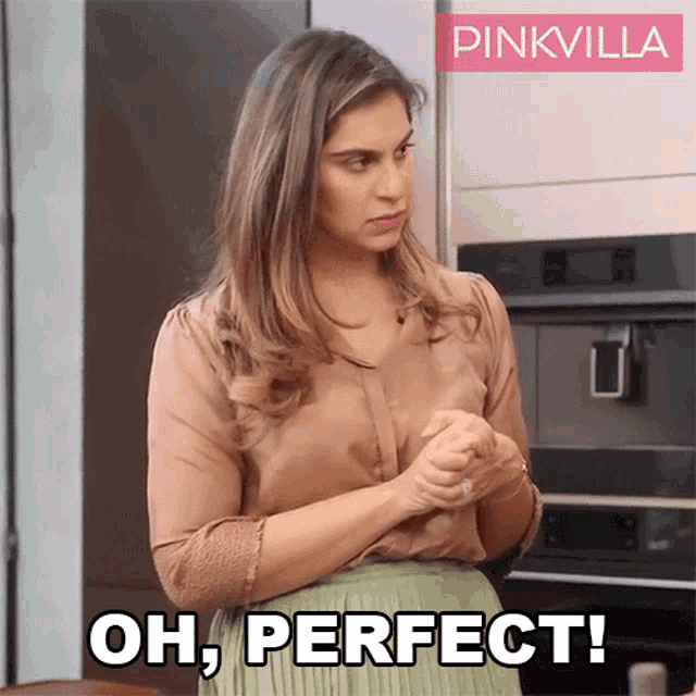 a woman in a brown shirt and green skirt is saying " oh perfect "