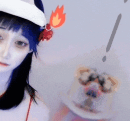 a girl wearing a red tank top and a white hat with flames on it .