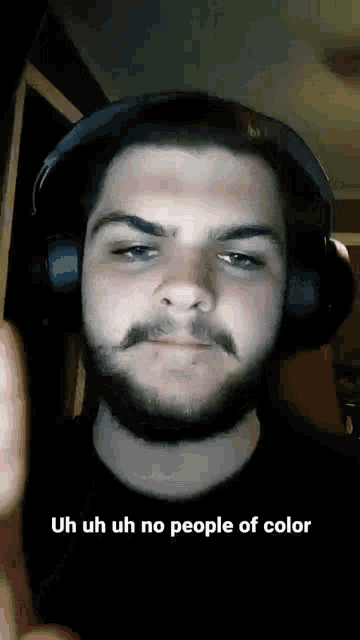 a man with a beard wearing headphones says uh uh uh no people of color .
