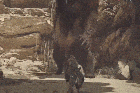 a person is standing next to a giant monster in a video game .