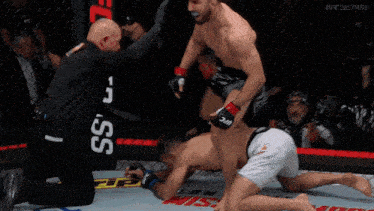 a man in a cage with a sign that says ufc fightpass