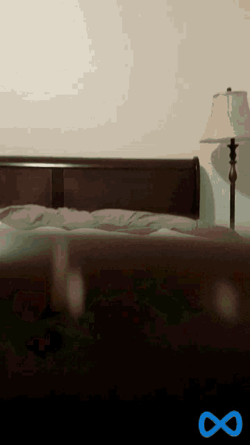 a bed with a lamp and an infinity symbol