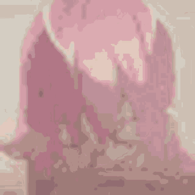 a close up of a woman with pink hair .