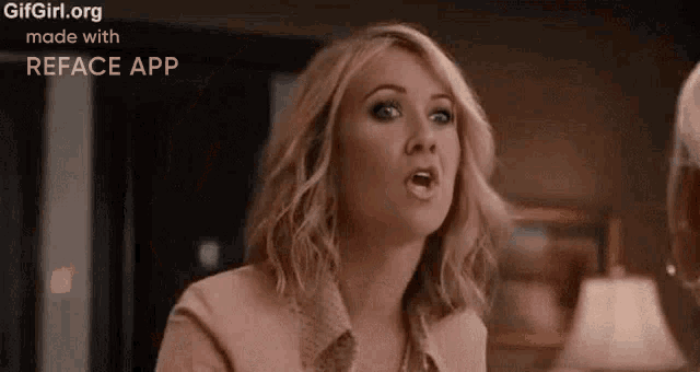 a woman is making a funny face while sitting at a table .