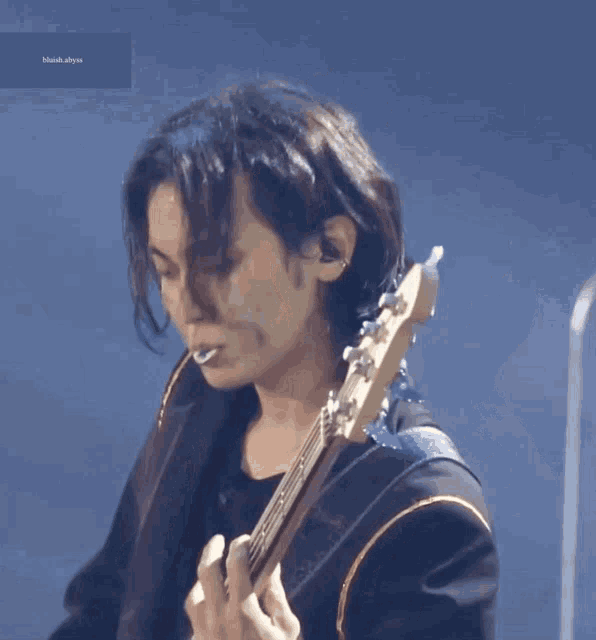 a man smoking a cigarette while playing a guitar with the word blank at the bottom