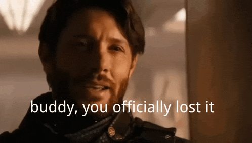 a man with a beard is standing in front of a window and says buddy , you officially lost it .