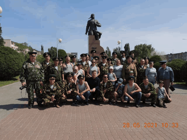 a group of soldiers posing for a photo on a brick sidewalk