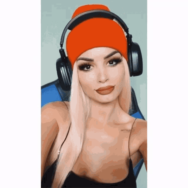 a woman wearing headphones and an orange hat