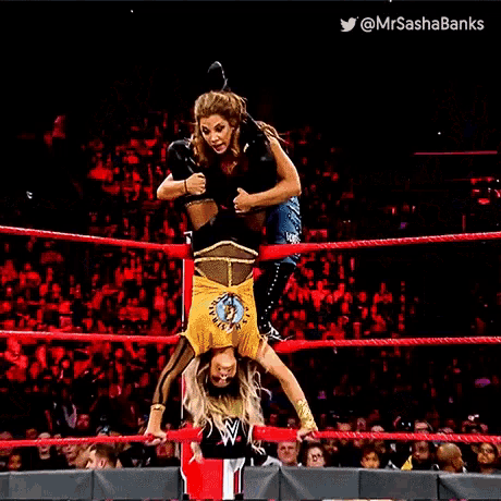 a woman is doing a handstand in a wrestling ring with the hashtag mrsashabanks at the bottom