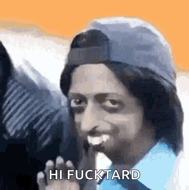 a man wearing a hat and a blue shirt is saying hi fucktard