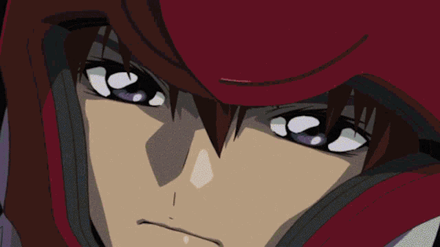 a close up of a person 's eyes with a red hat