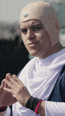 a man wearing a white shirt and a bald head